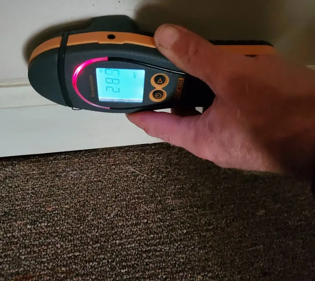 Moisture detection at baseboard during Storm Damage Restoration in Pace